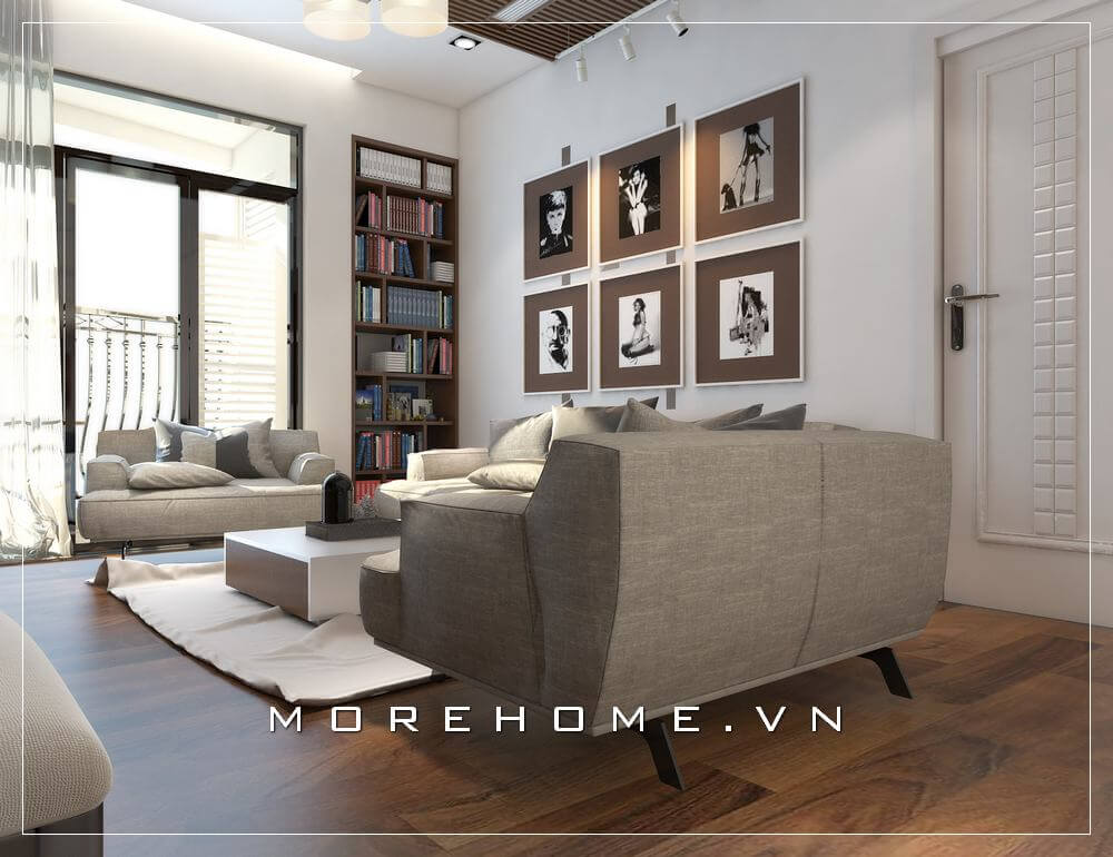 Một góc nhỏ nội thất phòng khách chung cư đẹp, nổi bật với bộ sofa bọc vải hiện đại, kế hợp những bức tranh treo độc đáo.